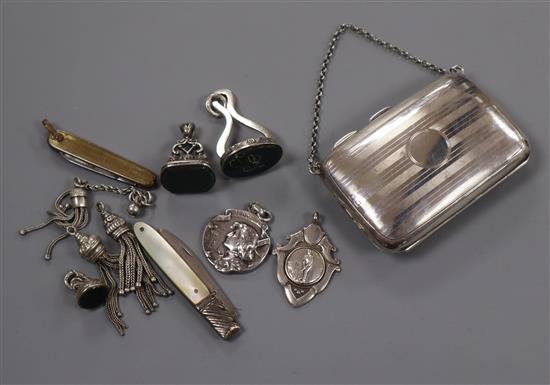 A George V silver purse, three silver fob seals, two fobs and sundries.